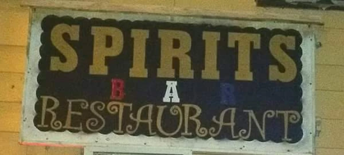 The painted SPIRITS BAR RESTAURANT sign on the clapboard front of 222 River Street